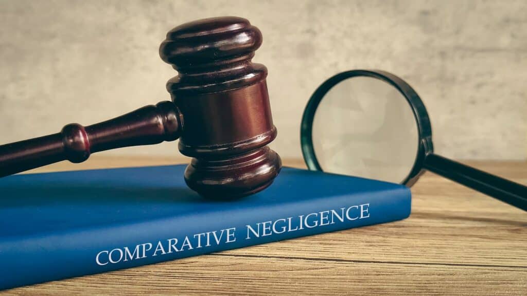 New York comparative negligence rule concept with gavel and law book explaining reduced compensation based on shared fault