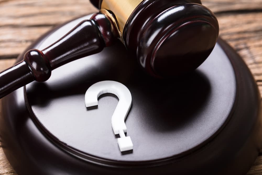 Closeup of question mark and Judge gavel Closeup of question mark and Judge gavel