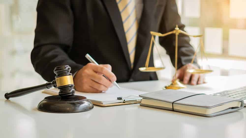 Personal injury lawyer signing document