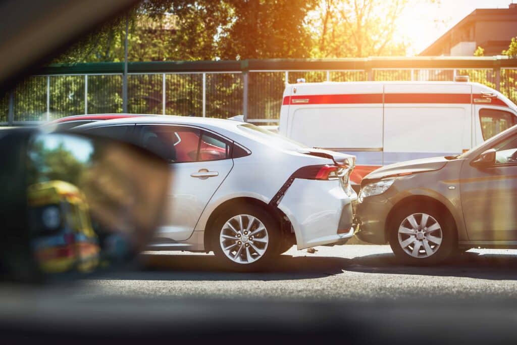 Rear-end car accident with vehicle damage and ambulance at the scene. Rear-end car accident with vehicle damage and ambulance at the scene.
