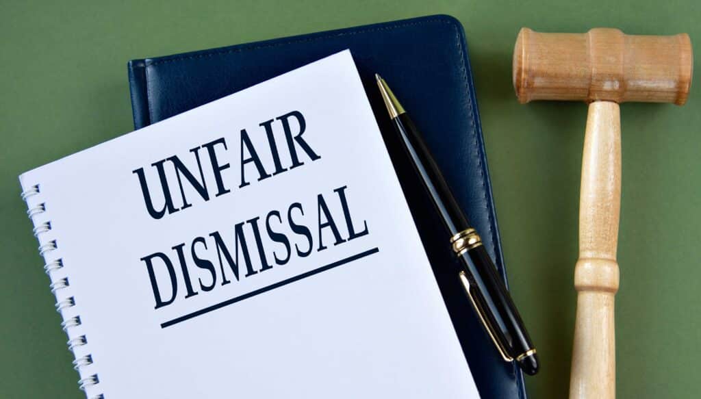 Unfair dismissal legal document with gavel representing wrongful termination claim. Unfair dismissal legal document with gavel representing wrongful termination claim.